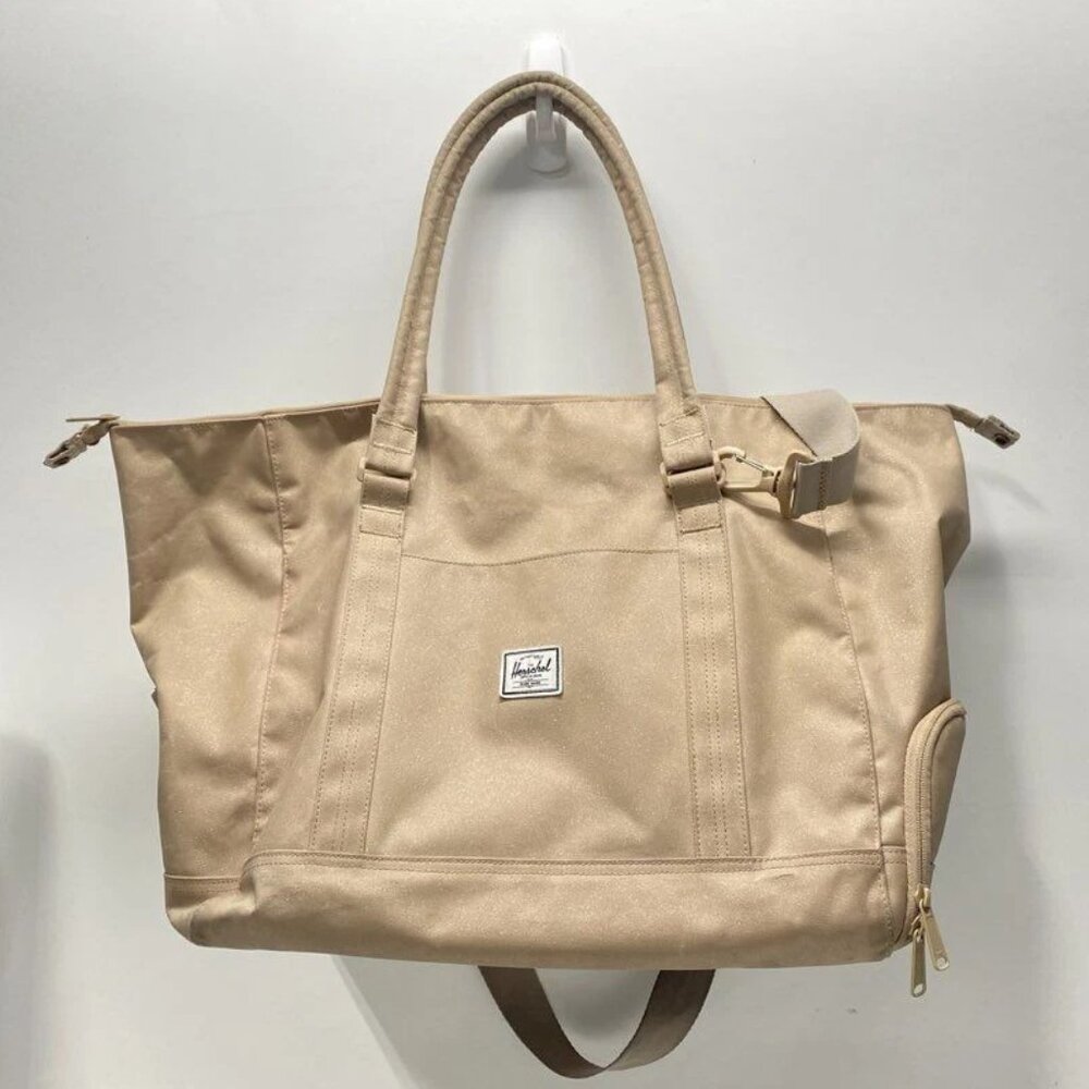 Herschel women's handbag in plain brown canvas with zipper closure.